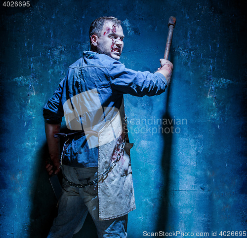 Image of Bloody Halloween theme: crazy killer as butcher with an ax