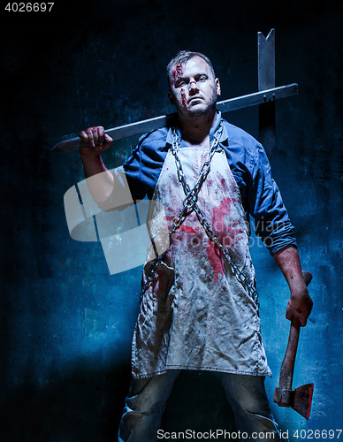 Image of Bloody Halloween theme: crazy killer as butcher with an ax