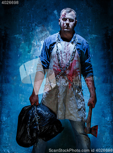 Image of Bloody Halloween theme: crazy killer as butcher with an ax