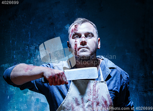 Image of Bloody Halloween theme: crazy killer as butcher with a knife