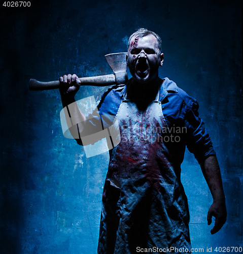 Image of Bloody Halloween theme: crazy killer as butcher with an ax