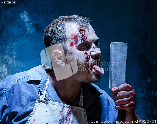 Image of Bloody Halloween theme: crazy killer as butcher with a knife