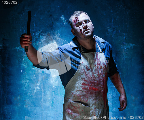 Image of Bloody Halloween theme: crazy killer as butcher with a knife