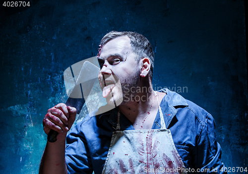 Image of Bloody Halloween theme: crazy killer as butcher with a knife