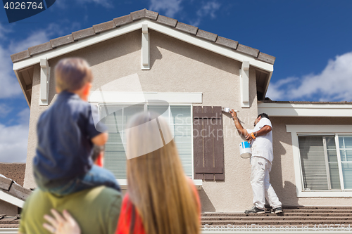 Image of Young Family Watching House Get Painted by Painter