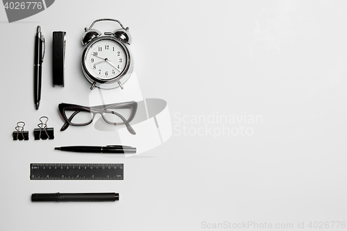 Image of The clock, pen, and glasses on white background