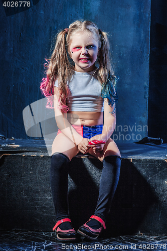 Image of The funny crasy girl with candy on dark background