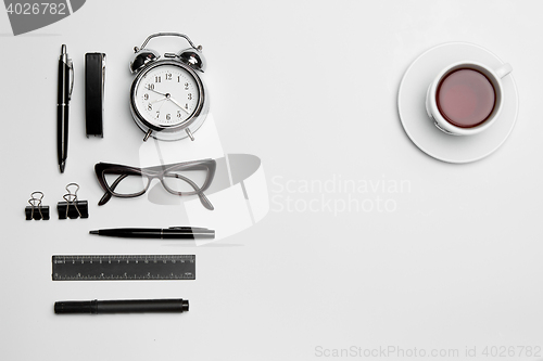 Image of The clock, pen, and glasses on white background