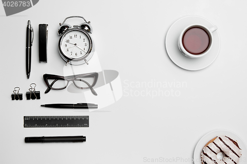 Image of The clock, pen, and glasses on white background