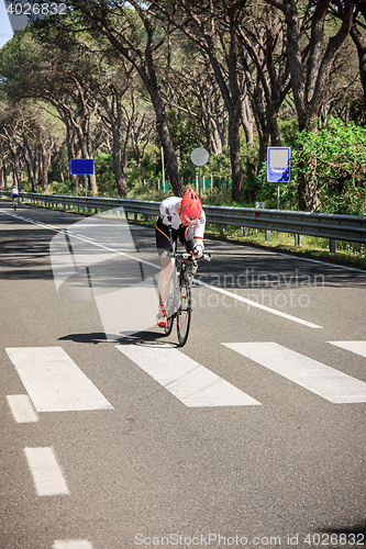 Image of Grosseto, Italy - May 09, 2014: The cyclist without an arm and feet with the bike during the sporting event