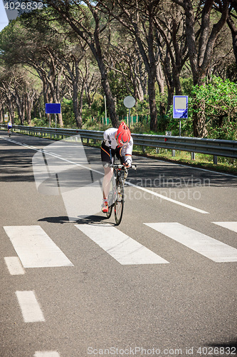 Image of Grosseto, Italy - May 09, 2014: The cyclist without an arm and feet with the bike during the sporting event
