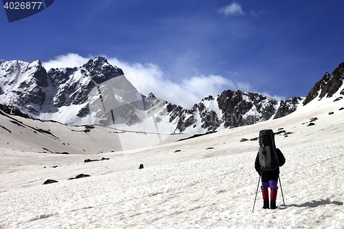 Image of Hiker on snow plateau at spring mountain.