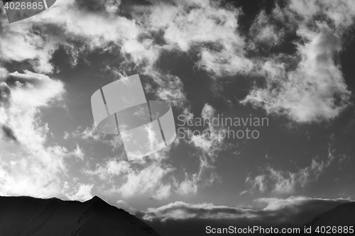 Image of Black and white sky with clouds and mountains in evening
