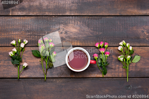 Image of Cup of coffee with roses, top view