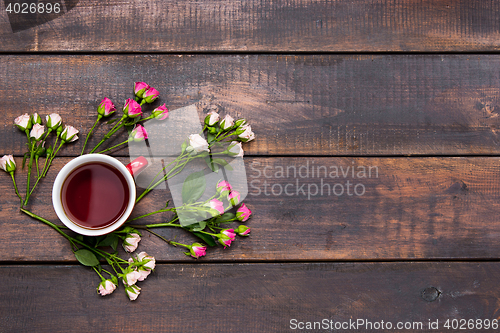 Image of Cup of coffee with roses, top view