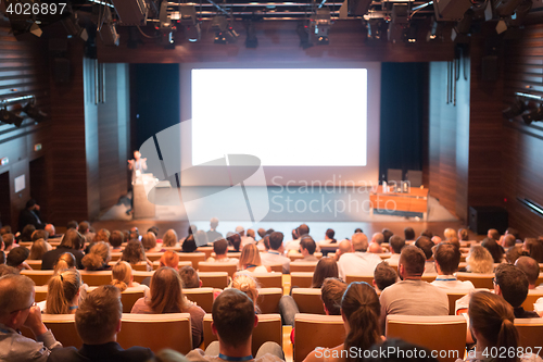 Image of Business speaker giving a talk in conference hall.