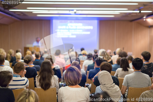 Image of Business speaker giving a talk in conference hall.