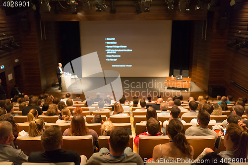 Image of Business speaker giving a talk in conference hall.