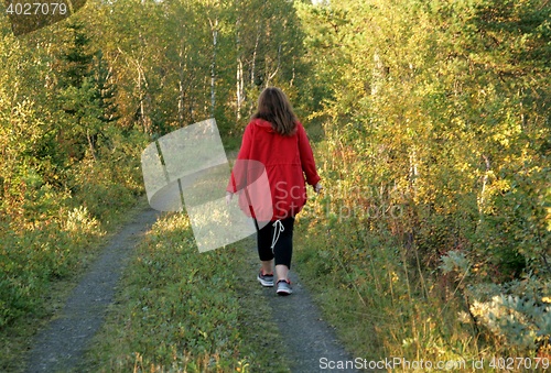 Image of Woman walking on a dirt road