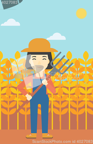 Image of Female farmer with pitchfork vector illustration.