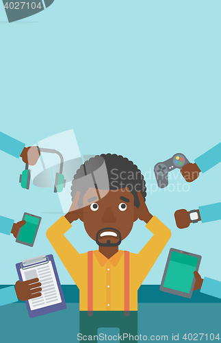 Image of Young man surrounded with his gadgets.