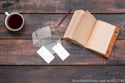 Image of Office desk table with cup, notebook, cards on wooden table