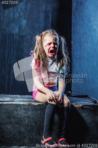 Image of The crying crasy girl on dark background