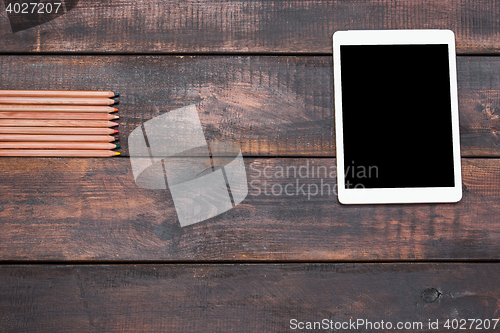 Image of Office desk table with laptop, pencils