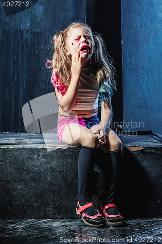 Image of The crying crasy girl on dark background