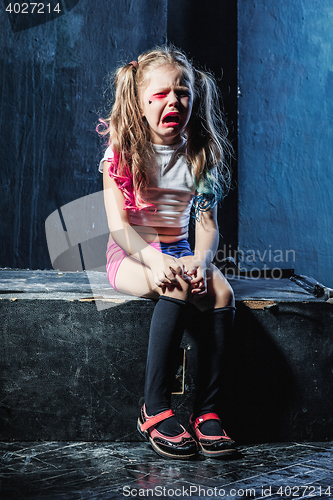 Image of The crying crasy girl on dark background