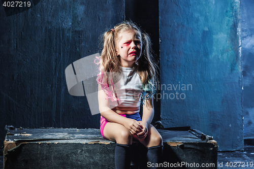 Image of The crying crasy girl on dark background