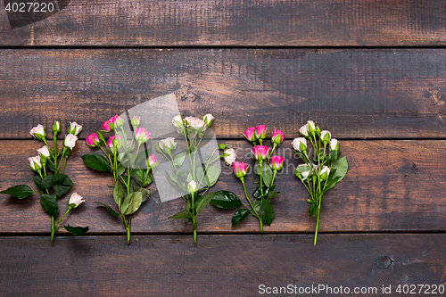 Image of The wooden table with roses, top view