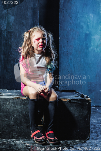 Image of The crying crasy girl on dark background