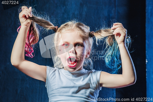 Image of The funny crasy girl on dark background