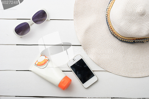 Image of Beach accessories on wooden board