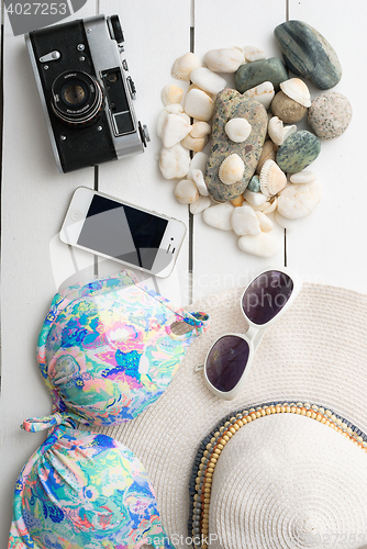 Image of Beach accessories on wooden board