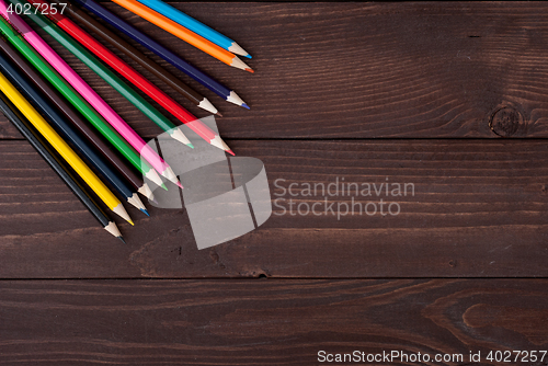 Image of Colored pencils on a wooden board