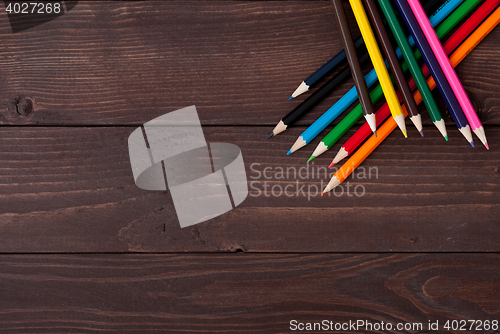 Image of Colored pencils on a wooden board