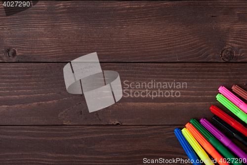 Image of Colored pencils on a wooden board