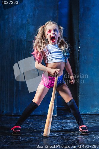 Image of Little girl pointing in toy gun