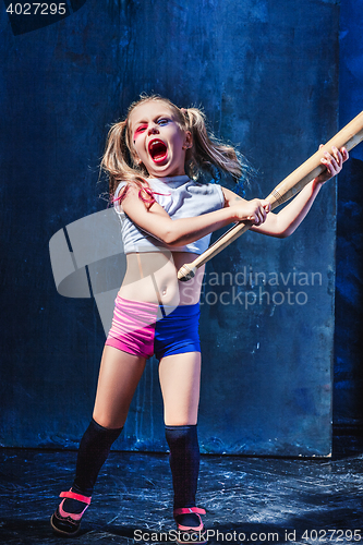 Image of Halloween theme: Girl with baseball bat ready to hit