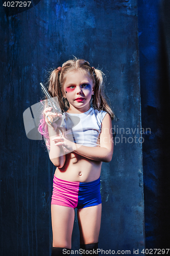 Image of Little girl pointing in toy gun