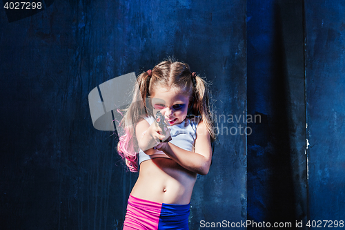 Image of Little girl pointing in toy gun