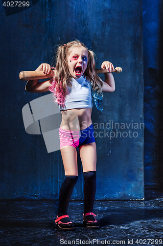 Image of Little girl pointing in toy gun