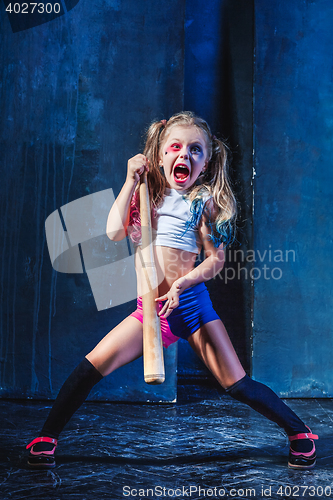 Image of Little girl pointing in toy gun