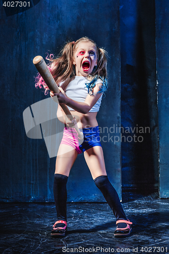 Image of Little girl pointing in toy gun