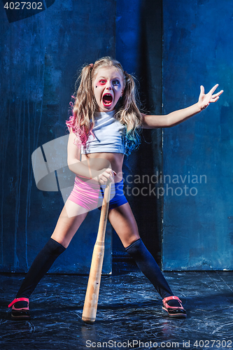 Image of Little girl pointing in toy gun