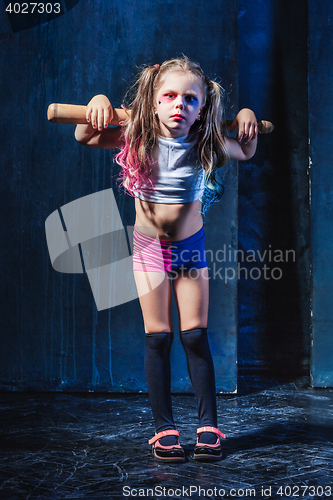 Image of Little girl pointing in toy gun