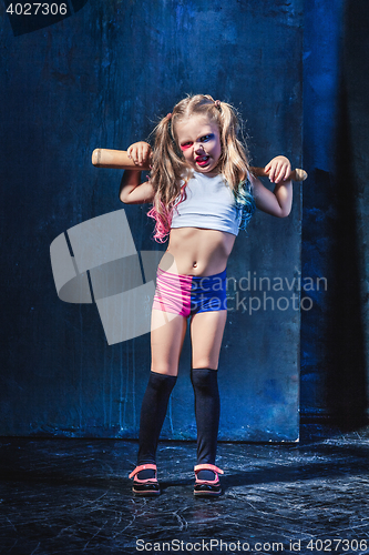 Image of Little girl pointing in toy gun