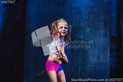 Image of Little girl pointing in toy gun